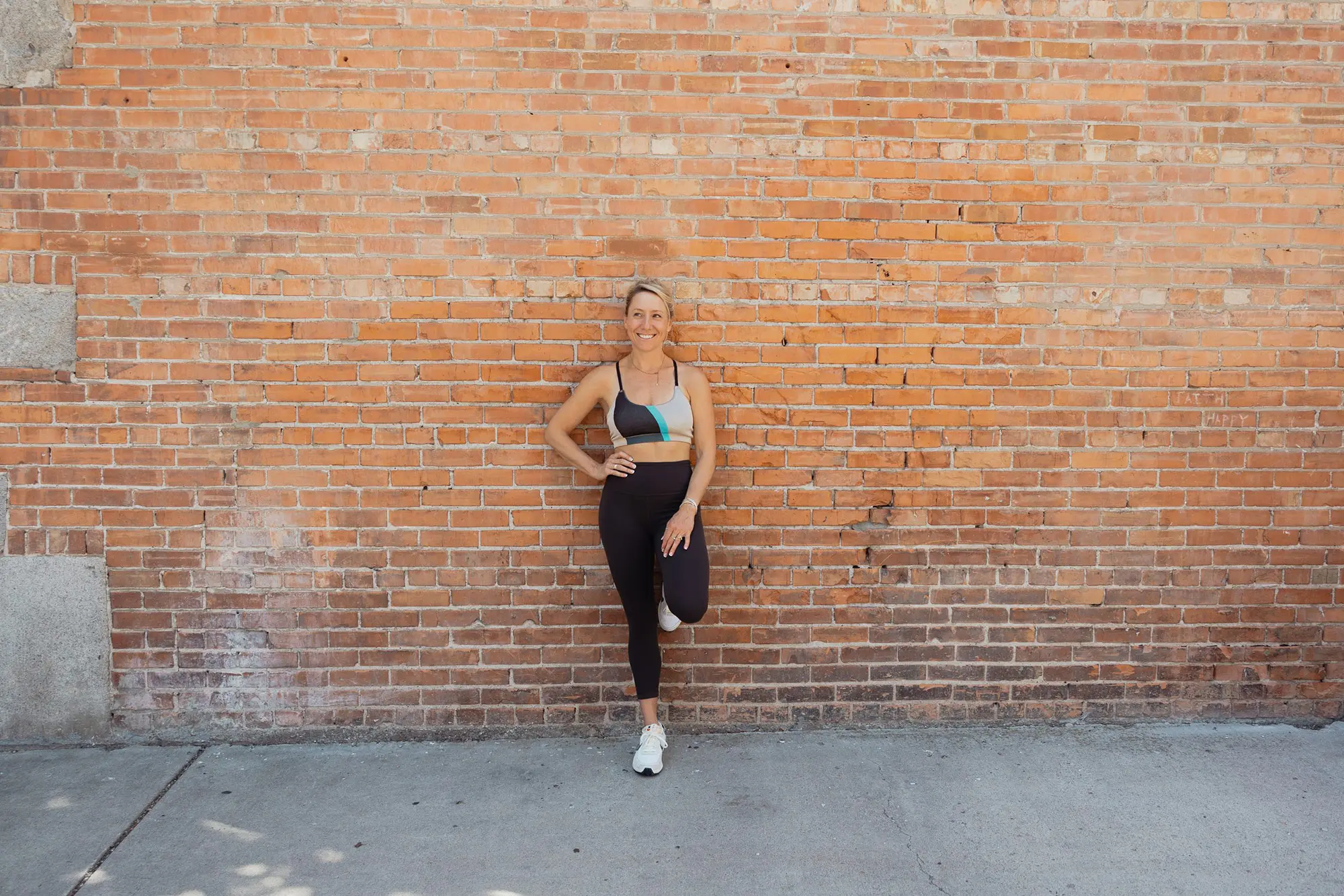 Stephanie Meyers, personal fitness trainer against a brickwall
